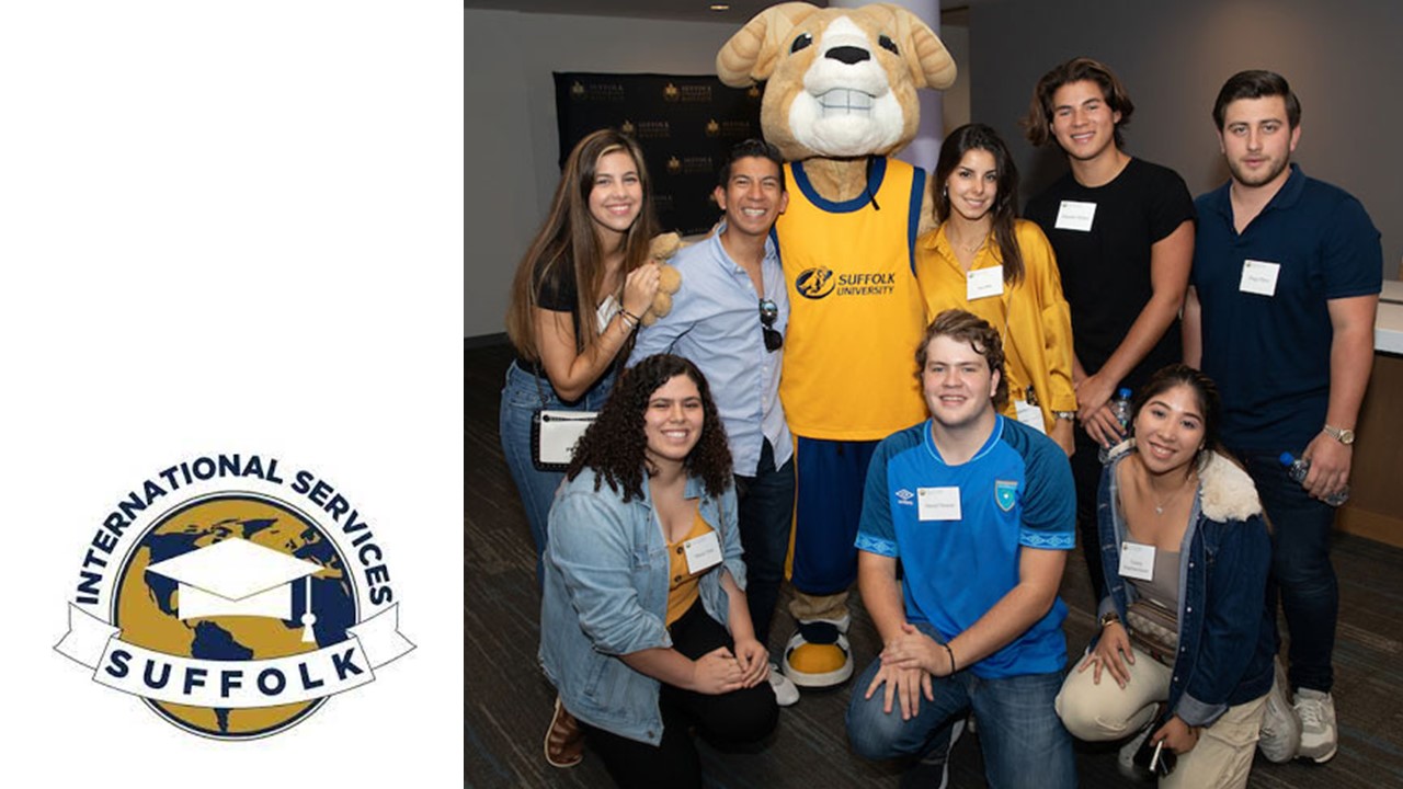 a group of international students taking a photo with Rammy, Suffolk's mascot. 
